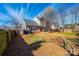 A spacious backyard features a fenced perimeter, mature trees, and a grass lawn at 102 Brewster Ct, Mooresville, NC 28115