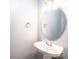 Small bathroom with a gray wall and a large oval mirror above a pedestal sink at 102 Brewster Ct, Mooresville, NC 28115