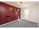 This bedroom features an accent wall, gray carpeting, and a window for lots of natural light at 102 Brewster Ct, Mooresville, NC 28115