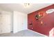 This bedroom features an accent wall, gray carpeting, a closet, and a small shelf at 102 Brewster Ct, Mooresville, NC 28115
