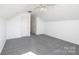 This bedroom features neutral paint, gray carpeting, a closet, and access to another room at 102 Brewster Ct, Mooresville, NC 28115