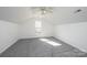 This bedroom features neutral paint, gray carpeting, and a window for lots of natural light at 102 Brewster Ct, Mooresville, NC 28115