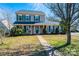Traditional two-story home with a well-maintained lawn, mature trees, and classic curb appeal at 102 Brewster Ct, Mooresville, NC 28115