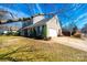 A tan, two-story home with green shutters, an attached garage, and a long driveway at 102 Brewster Ct, Mooresville, NC 28115