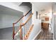 Bright foyer with wood-trimmed staircase and a view into the adjacent kitchen at 102 Brewster Ct, Mooresville, NC 28115
