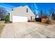 Spacious garage with an extended driveway and neat landscaping along the side of the house at 102 Brewster Ct, Mooresville, NC 28115