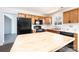 Traditional eat-in kitchen features wooden cabinets, a large island, and black appliances at 102 Brewster Ct, Mooresville, NC 28115