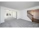 Spacious living room with neutral carpet and walls, flooded with natural light from the large windows at 102 Brewster Ct, Mooresville, NC 28115