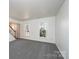 Bright living room featuring neutral carpet and large windows offering a view of the outdoors at 102 Brewster Ct, Mooresville, NC 28115