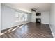 Comfortable living room with a fireplace, ceiling fan, and dark-colored laminate flooring at 102 Brewster Ct, Mooresville, NC 28115