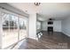 Open concept living room with fireplace, ceiling fan, and sliding glass doors to the backyard at 102 Brewster Ct, Mooresville, NC 28115