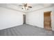 Bright main bedroom with a ceiling fan, two windows, new carpet, and an ensuite bathroom at 102 Brewster Ct, Mooresville, NC 28115