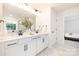 Bathroom with a large mirror, dual sinks, and light-colored walls at 149 Saidin Ln, Troutman, NC 28166