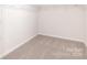 Walk-in closet features neutral carpet and shelving at 149 Saidin Ln, Troutman, NC 28166