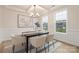 Bright dining area with modern decor, a sleek table, and views of the outdoors through large windows at 149 Saidin Ln, Troutman, NC 28166