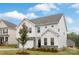 Charming two-story home with white siding, stone accents, a well-manicured lawn, and an attached two-car garage at 149 Saidin Ln, Troutman, NC 28166