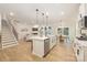 Bright open kitchen features a large island with stainless steel appliances and light wood flooring at 149 Saidin Ln, Troutman, NC 28166