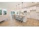 Open-concept kitchen featuring a large island, modern appliances, and seamless flow into the dining area at 149 Saidin Ln, Troutman, NC 28166