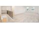 Open loft space features neutral carpet, two windows, and staircase at 149 Saidin Ln, Troutman, NC 28166