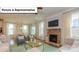 Warm living room with a cozy fireplace, inviting seating, and views to the outdoor living space at 153 Saidin Ln, Troutman, NC 28166