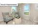 Sitting room with comfortable seating and large windows looking out on the neighborhood at 153 Saidin Ln, Troutman, NC 28166