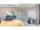 A bright and open bedroom with a drum set, a large mirror, and a dark dresser at 157 Saidin Ln, Troutman, NC 28166