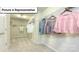 Spacious walk-in closet offers ample storage with hanging racks and shelving at 157 Saidin Ln, Troutman, NC 28166