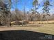Serene backyard view showcasing tall pine trees under a clear blue sky at 167 Patterson Rd, Kings Mountain, NC 28086