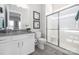 Modern bathroom featuring a glass-door shower, granite countertop, and white cabinets at 234 Pintail Dr, Monroe, NC 28110