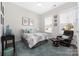 Comfortable bedroom featuring a ceiling fan, window, accent rug, and accent chair at 234 Pintail Dr, Monroe, NC 28110