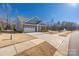 A single-Gathering home boasts a well-manicured lawn, long driveway and two-car garage at 234 Pintail Dr, Monroe, NC 28110
