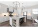 Bright, modern kitchen with white cabinets, large island, quartz countertops, and stylish pendants at 234 Pintail Dr, Monroe, NC 28110