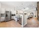 Modern kitchen with stainless steel appliances, white cabinetry, and an open floor plan at 234 Pintail Dr, Monroe, NC 28110