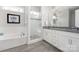 Modern main bathroom with double vanity, soaking tub, and glass-enclosed shower at 234 Pintail Dr, Monroe, NC 28110