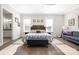 Serene primary bedroom with large windows, seating area, and hardwood floors at 234 Pintail Dr, Monroe, NC 28110