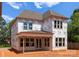 The back of a new construction home shows Tyvek wrap and many windows at 2530 Elkwood Cir, Charlotte, NC 28205