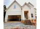 Eye-catching home featuring an attached two-car garage, covered entryway, and wood-stained entry stairs at 2530 Elkwood Cir, Charlotte, NC 28205