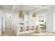 Bright kitchen boasts white cabinets, gold hardware, pendant lighting, and a large island with bar seating at 2530 Elkwood Cir, Charlotte, NC 28205