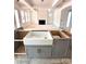 Unfinished kitchen featuring a farmhouse sink and modern cabinetry at 2530 Elkwood Cir, Charlotte, NC 28205
