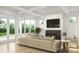 Open living room featuring coffered ceilings, a modern fireplace, large windows, and access to the backyard at 2530 Elkwood Cir, Charlotte, NC 28205