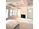 Unfinished living room with a tray ceiling, fireplace, and large windows at 2530 Elkwood Cir, Charlotte, NC 28205