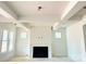 Open living room featuring a fireplace with black trim, and large windows for natural light at 2530 Elkwood Cir, Charlotte, NC 28205