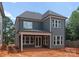 Rear exterior of new construction home with covered patio and lots of windows at 2530 Elkwood Cir, Charlotte, NC 28205