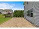 Spacious backyard with lush grass, privacy landscaping, and a large stone paver patio at 3008 Dundee Ln, Fort Mill, SC 29707