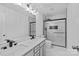 Modern bathroom with double vanity, white marble tile, and glass-enclosed shower with black fixtures at 3008 Dundee Ln, Fort Mill, SC 29707