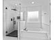 Modern bathroom with a bathtub and a glass-enclosed shower at 3008 Dundee Ln, Fort Mill, SC 29707