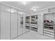 Luxurious walk-in closet featuring custom shelving, mirrored doors, and elegant chandelier lighting at 3008 Dundee Ln, Fort Mill, SC 29707