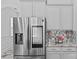 Modern kitchen with stainless steel refrigerator, gray cabinets, and a decorative backsplash at 3008 Dundee Ln, Fort Mill, SC 29707