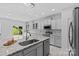 Bright, white kitchen featuring granite countertops, stainless steel appliances, and a modern chandelier at 3008 Dundee Ln, Fort Mill, SC 29707
