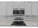 Modern kitchen featuring stainless steel appliances, granite countertops, and a decorative backsplash at 3008 Dundee Ln, Fort Mill, SC 29707
